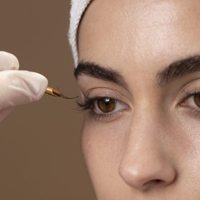 woman-doing-eyelashes-treatment-her-client